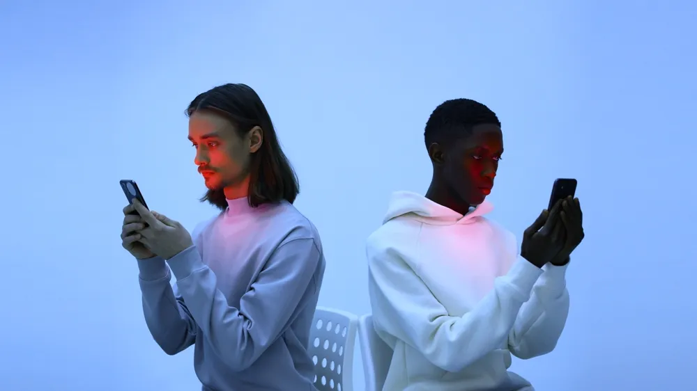 Two people using mobile phones