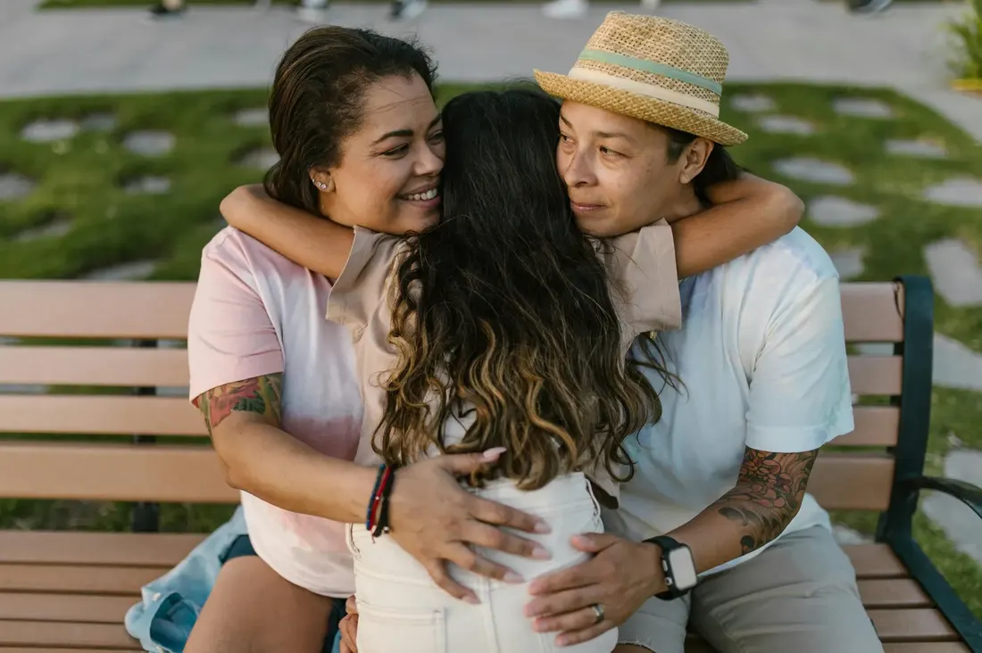 A family sharing an embrace on a sunny afternoon — the kind of connection VICCIR works to support